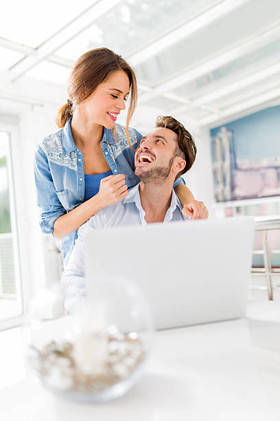 istock Cheerful embraced couple talking to each other at home. 486981044