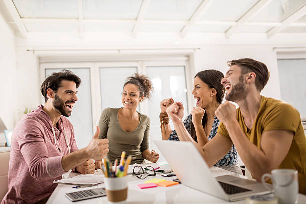 istock Cheerful creative people celebrating their business achievement at office. 486981058