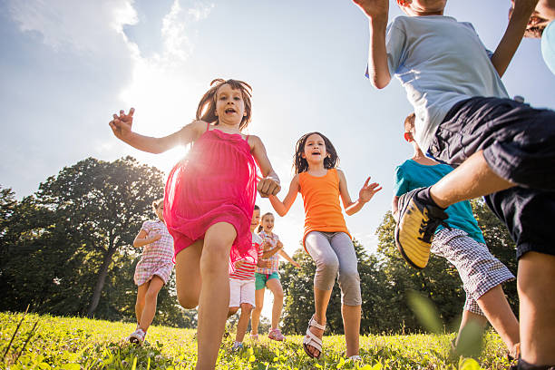 istock Below view of happy children running during spring day. 486981166