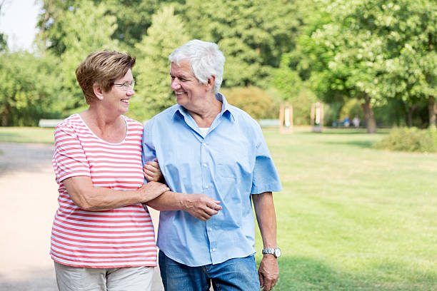 istock Happy senior couple walking outdoors in the park 486981452