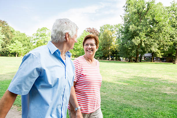 istock Happy senior couple walking outdoors in the park 486981454