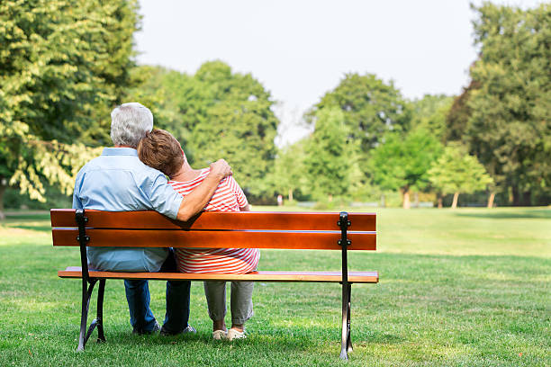 istock Senior adults outdoors in the park on park bench 486981456