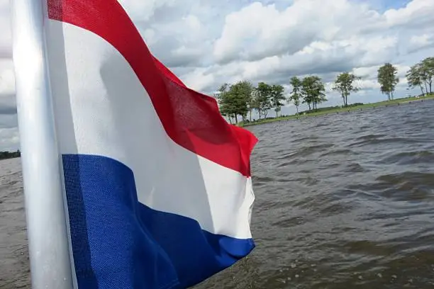 Dutch flag in nature on the cruiseship of the "Zilvermeeuw" in the national park the Biesbosch, Netherlands.
