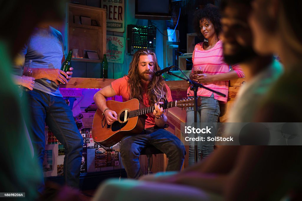 Singer/Songwriter Playing in Local Bar Singer/songwriter playing a gig at a local bar/pub. Music Stock Photo