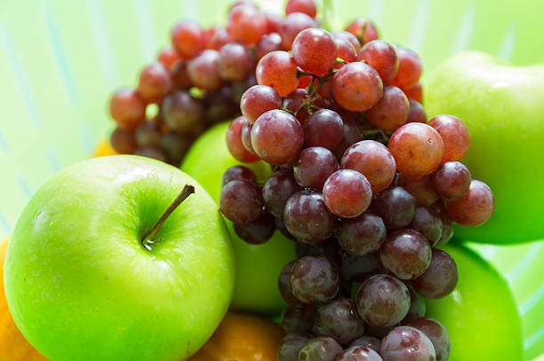 istock Apple, grapes and orange in the basket 486982084