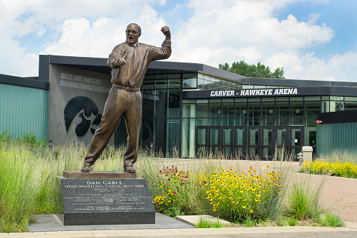 Iowa City, United States - August 7, 2015: Dan Gable head wrestling coach statue at the University of Iowa. The University of Iowa is a flagship public research university.
