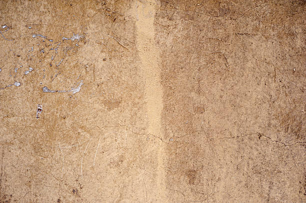 istock Texture of old wall covered with yellow stucco 486992716