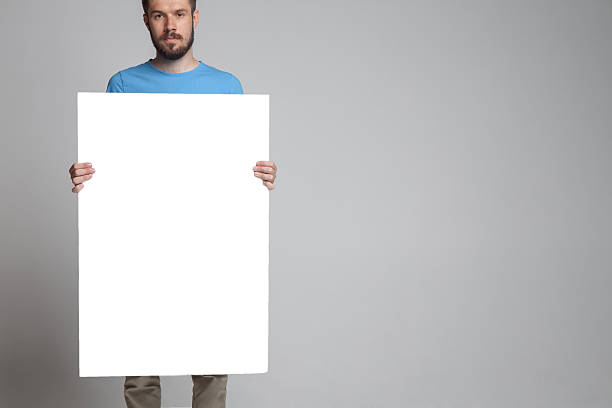 istock The man showing empty white billboard or banner 486993832