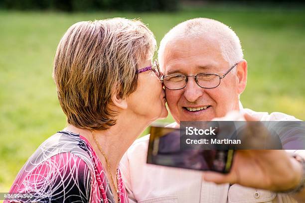Capturing Moments Senior Couple Stock Photo - Download Image Now - 2015, Active Seniors, Adult