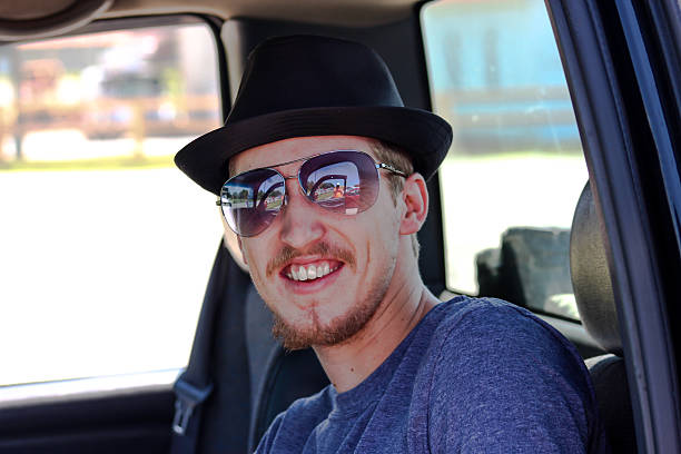 istock Man Sitting in Truck Smiles For Camera 486995676