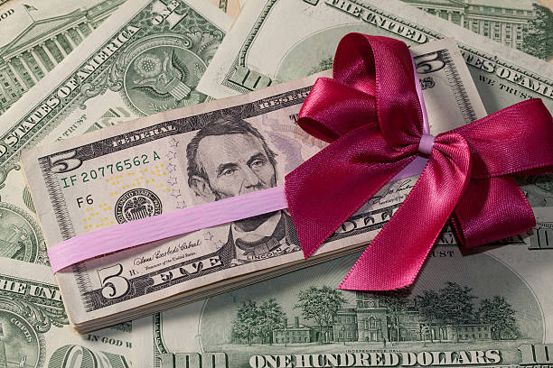 istock Pack of dollar bills with red bow 486997039