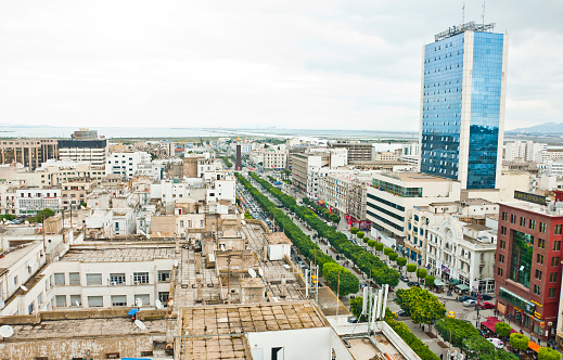 Tunis, Tunisia - April 20, 2011: Overlooking view from Bourguiba Avenue in central Tunis, the capital city of Tunisia. The high building on the right is the famous Africa Hotel.