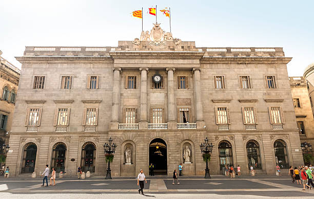 The Palau de la Generalitat Barcelona, Spain - July 6, 2015: The Palau de la Generalitat is a historic palace in Barcelona, Catalonia, Spain. It houses the offices of the Presidency of the government of Catanonia. People are walking by square. palau stock pictures, royalty-free photos & images