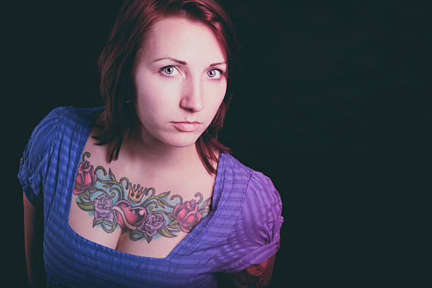 istock beautiful woman with tattoo in black background 487002045