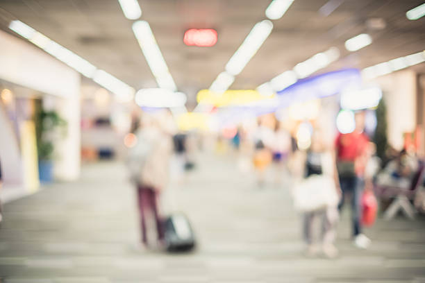 istock Blurred background : Traveler with baggage at airport terminal b 487012246