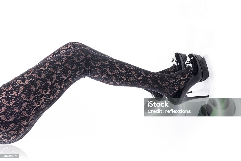 Sexy stockings Isolated sexy legs with stockings and shoes over white background 2015 Stock Photo