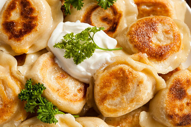 istock Homemade Polish Pierogis with Sour Cream 487016749