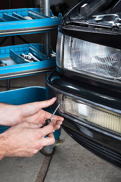 istock Car fog headlight mechanic repair 487018114