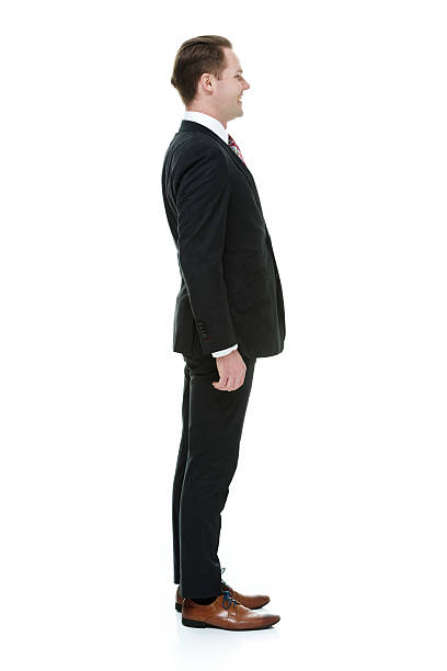 istock Smiling businessman standing and looking away 487018204