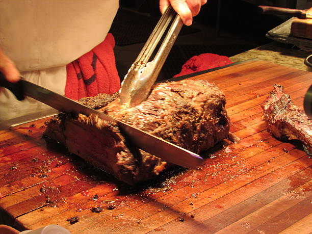 Carving station you can taste the juice prime rib carved at the carving station by the chef station stock pictures, royalty-free photos & images