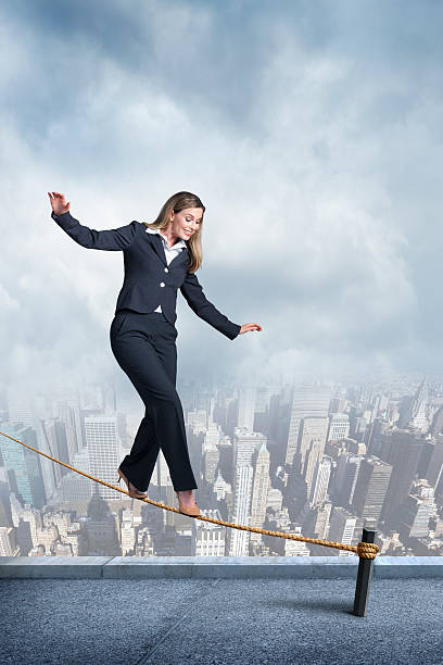istock Businesswoman Balancing On A Tightrope 487021384