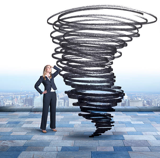 istock Businesswoman Looking Up At Tornado 487021392