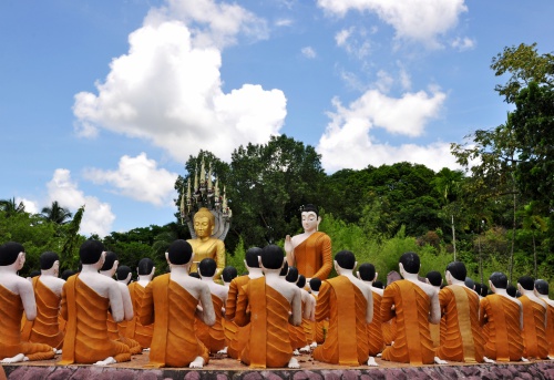 Buddha and monks statue against blue sky at Wat Chak Yai, Chanthaburi, Thailand