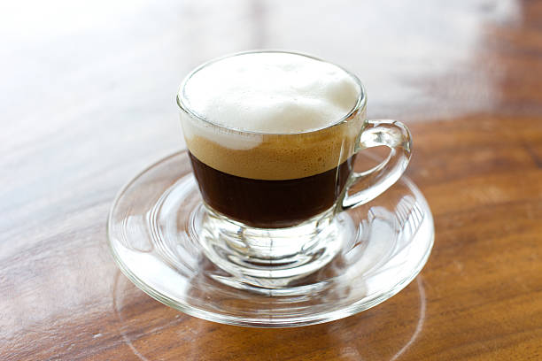 istock Hot  espresso with milk and foam in cup. 487022127