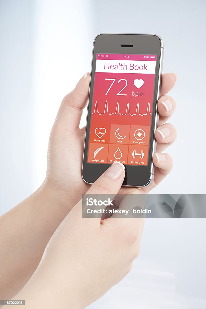 Health book app is scanning heartbeat cardiogram Woman is scanning heartbeat cardiogram by modern smartphone with health book app on the screen. Healthcare And Medicine Stock Photo