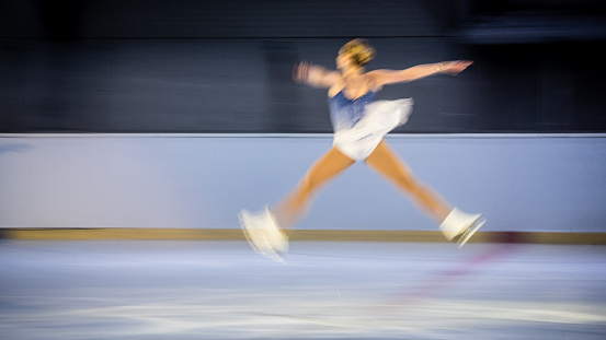 Female figure skater performing, long exposure.