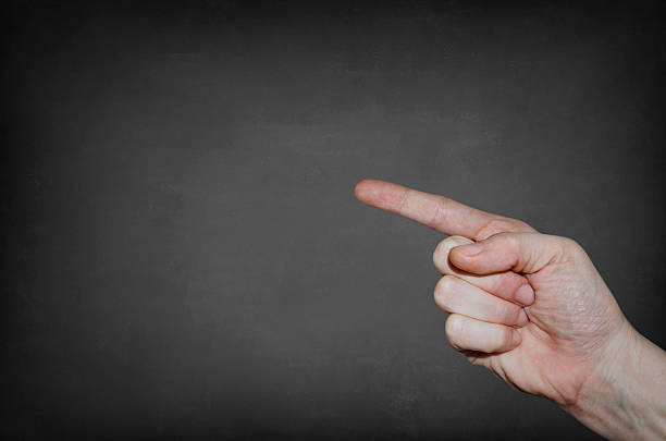 istock Finger point at the blank blackboard 487022526