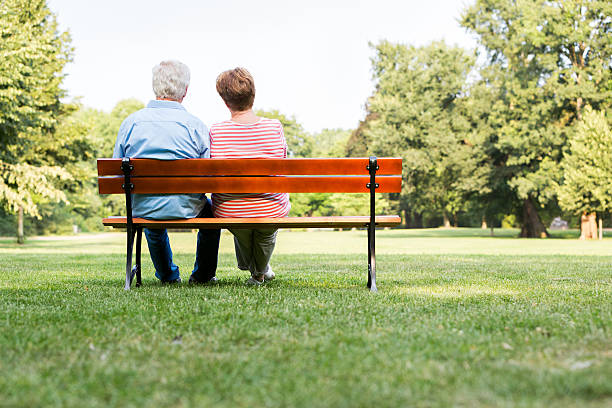 istock Senior adults outdoors in the park on park bench 487026328