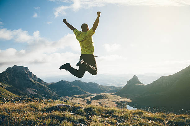 Freedom. Independence. Freedom. Man jumping in the air with mountain landscape on background. durmitor national park photos stock pictures, royalty-free photos & images