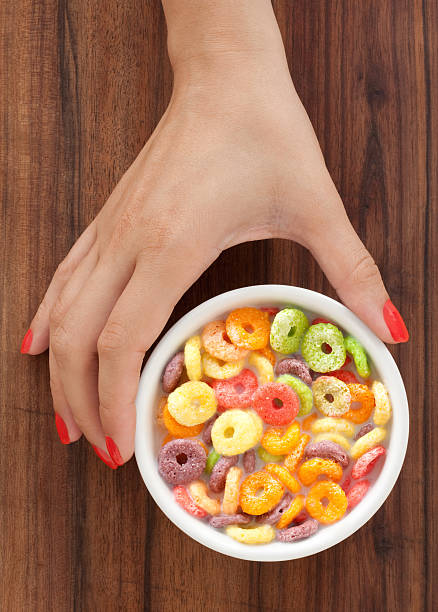 Offering multicolored cereal rings with milk