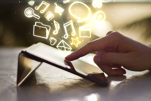istock man clicks on digital tablet at sunrise 487035952