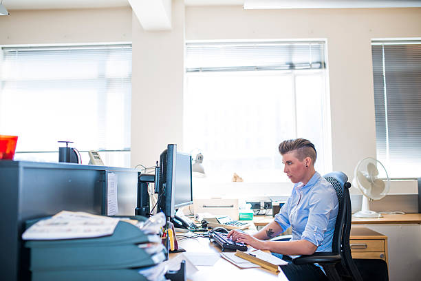 istock Side view of businesswoman using desktop PC in office 487035984