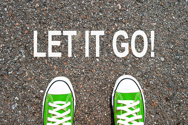 istock Feet concept with green sneakers on black background 487036642