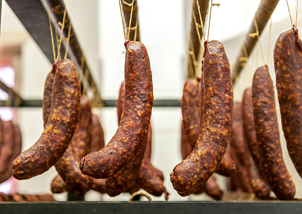istock close up of fresh sausages on rack 487039932