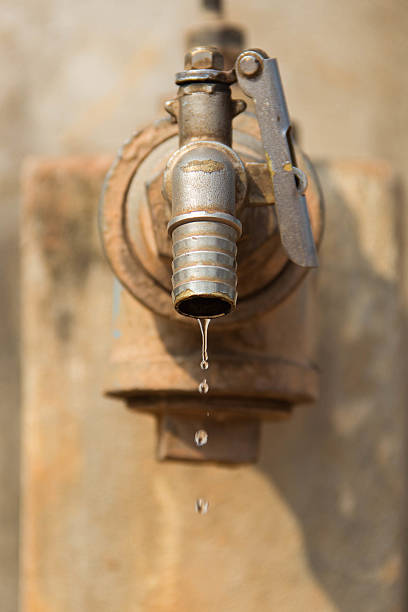 istock Leaking faucet, wasting water in the hot daylight 487040156