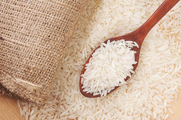 istock Rice, White rice in wooden spoon with hemp 487040502