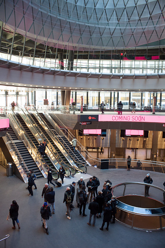 New York City, NY, USA - February 11, 2015: Fulton Center Transit Hub, NYC. Commuters head to their destinations. Tourists stand around the lobby of the station.