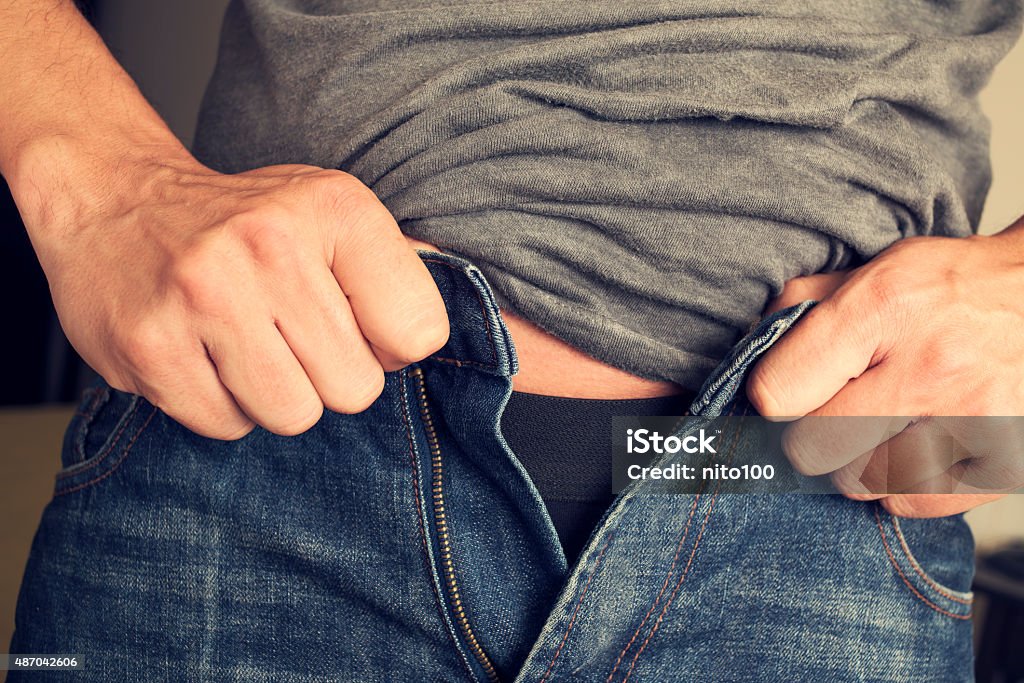 Young Man Trying To Fasten His Trousers Stock Photo - Download Image Now -  Buttoning, Men, Pants - iStock