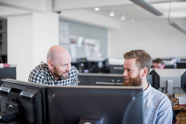 istock Businessmen discussing at desk in office 487045076