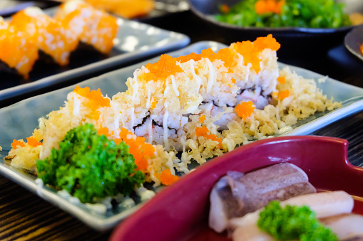 Shrimp nigiri sushi on black slate.