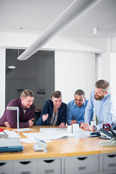 istock Business team analysing blueprint together in office 487045428