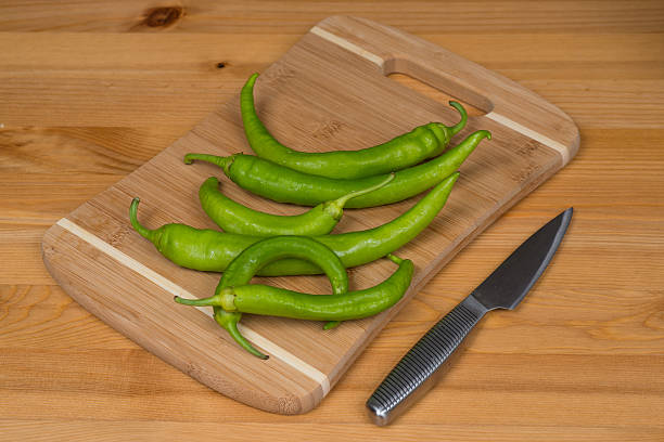istock Green peppers on a wooden surface 487046044