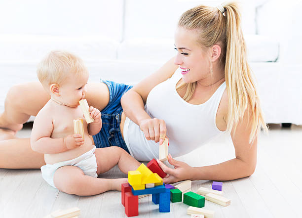 istock Mother and baby playing with blocks 487046482
