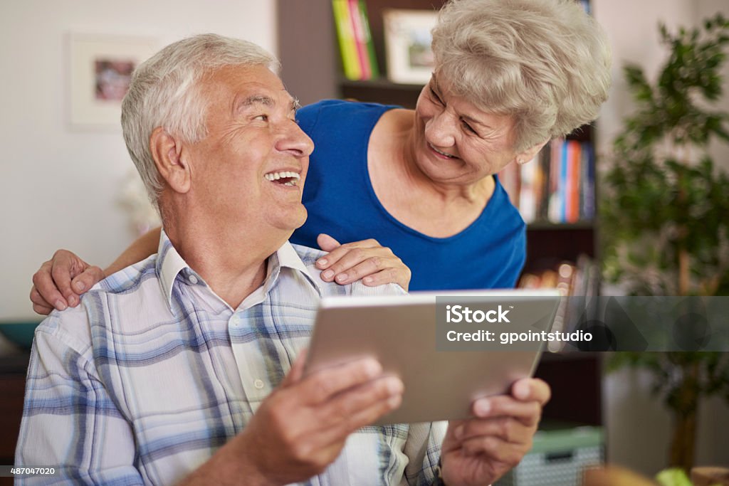 Using a tablet is not a problem for grandparents Grandfather Stock Photo