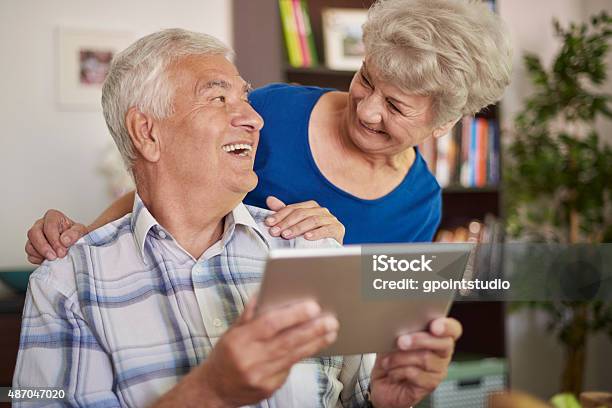 Using A Tablet Is Not A Problem For Grandparents Stock Photo - Download Image Now - Grandfather, 2015, Active Seniors