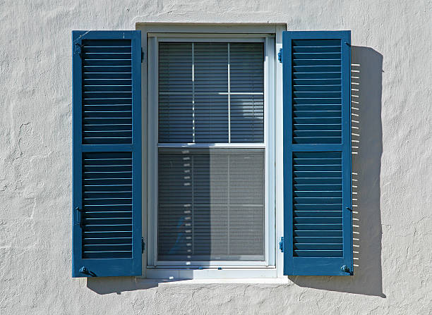 Open Blue Window Shutters Open blue window shutters, against a white wall, in a hot country shutter stock pictures, royalty-free photos & images